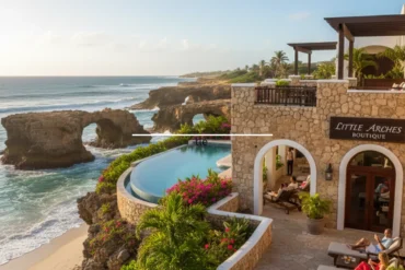 Little Arches in Barbados Boutique Hotel overlooking the Caribbean Sea, featuring an infinity pool, stone architecture, tropical plants, and ocean rock arches at sunset.