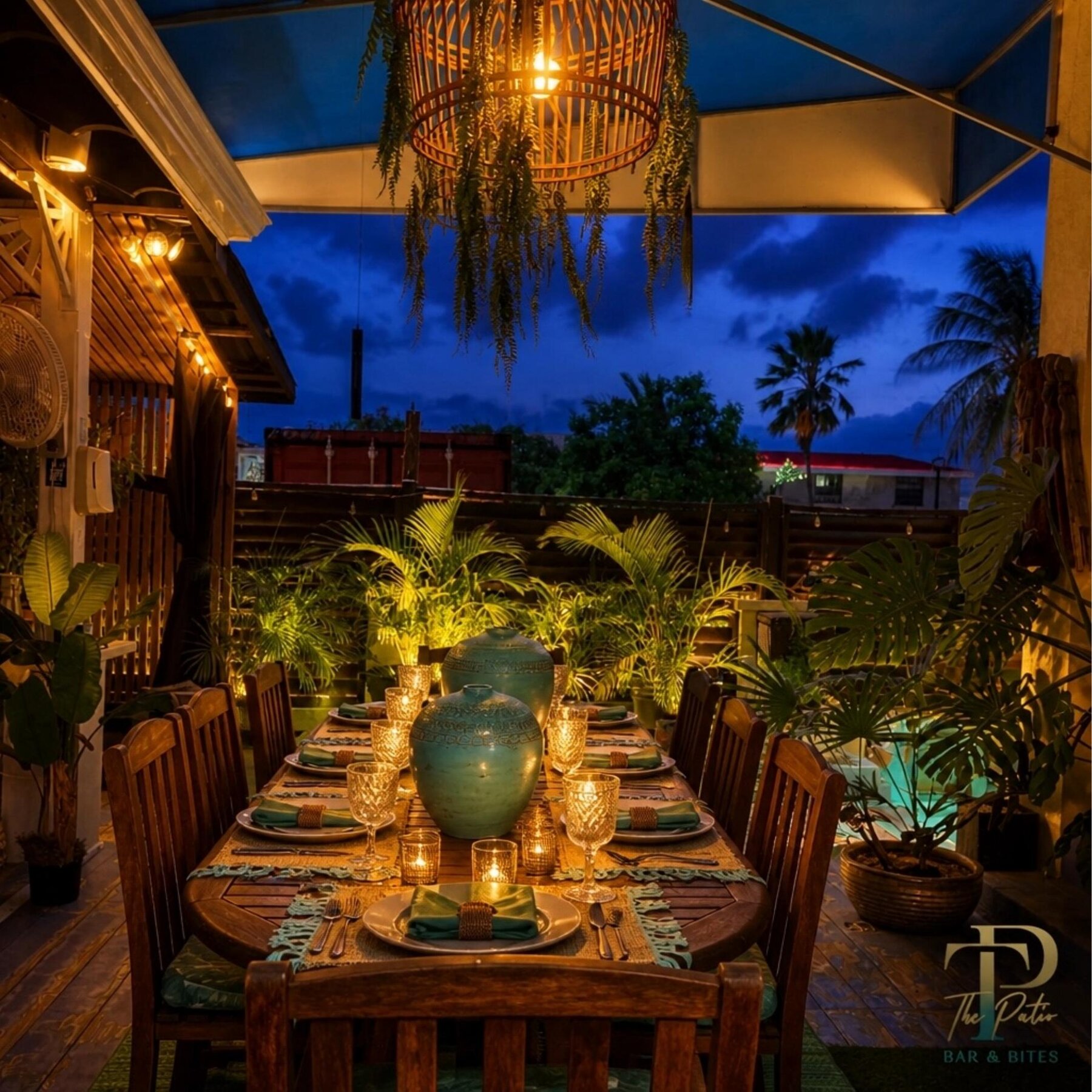 An elegant candlelit dinner table set for a celebration at The Patio