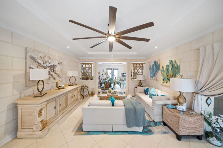 The open-plan living room at Hidden Gem Barbados, with coral stone walls and pale linen seating
