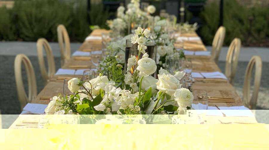 An elegant candlelit dinner table set for a celebration at The Patio